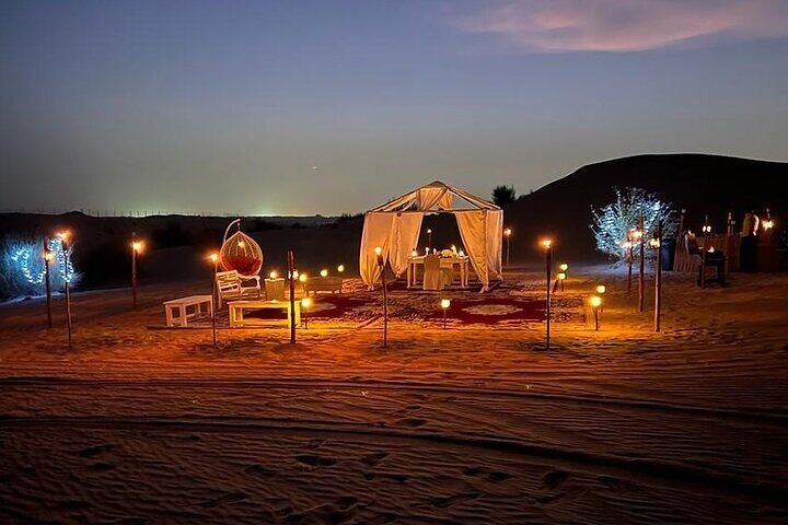 Discover an unforgettable evening under the stars complete with a cozy desert setup traditional carpets and a delicious barbecue dinner all enhanced by mesmerizing entertainment.